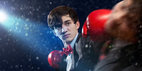Two young businessman boxing