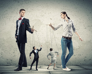 Businesspeople with marionettes