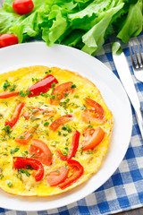 Omelet with paprika, tomato and herbs