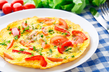 Omelet with paprika, tomato and herbs