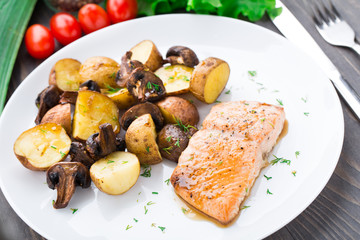 Roasted salmon with potatoes and mushrooms
