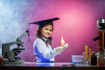 Nice girl conducting physical experience in lab