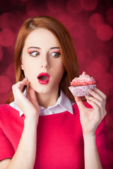 Redhead girl with cake.