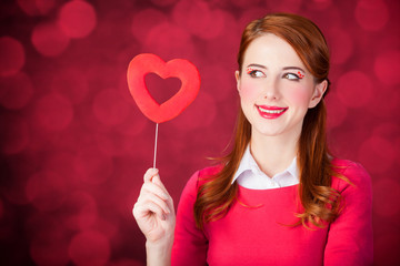 Redhead girl with shape heart toy.