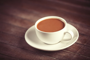 Cup of coffee on wooden table.