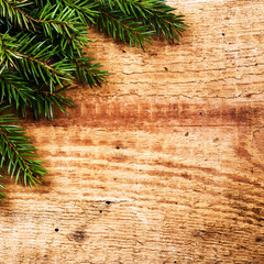 Christmas Background with Fir Tree Branch on wooden background w