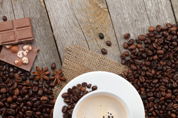 Coffee cup and chocolate on wooden table