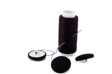 black thread with needle and buttons