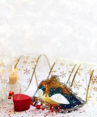 Christmas background with a mask, gifts and candles