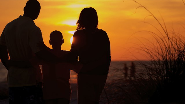 African American Family Enjoying Beach Vacation Sunset