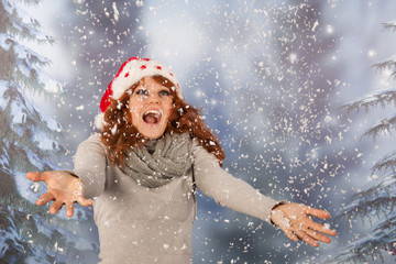 Winter woman with hat of Christmas Santa in snow