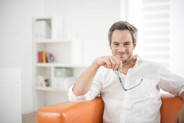 attractive man smiling on a couch