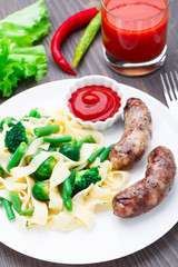 Fettuccine with vegetables and fried sausages