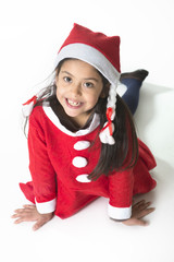 Cute Little Girl in Santa Claus costume posing happy at Xmas