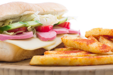 Salami sandwich with french fries close-up