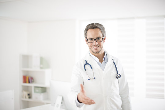 Young Doctor Welcoming At His Office