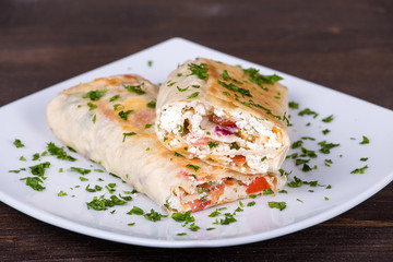 Pita bread wrapped with cottage cheese and vegetables