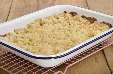 warm baked apple crumble in an enamel bowl
