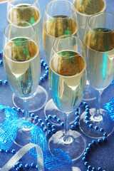 Glasses with champagne on shiny background