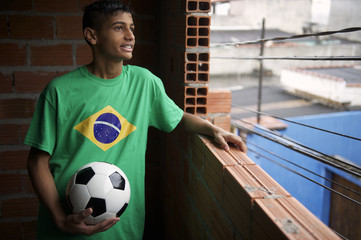 Smiling Brazilian Soccer Player Looks Out Favela Window