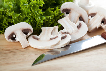 Mushrooms with knife on chopping board