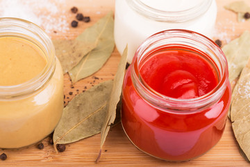 Ketchup and other sauces, spices on the cutting board