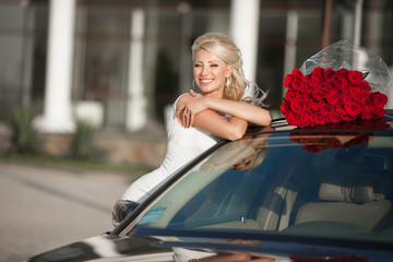 beautiful woman with flowers and luxury car outdoor