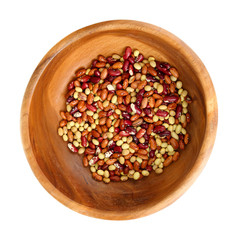 Beans in wooden bowl isolated on white