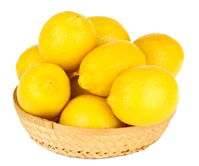 Ripe lemons in wicker basket isolated on white