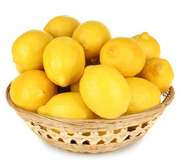 Ripe lemons in wicker basket isolated on white