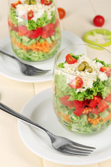 Tasty salad with fresh vegetables on wooden table