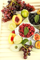 Assortment of juicy fruits and berries on wooden background