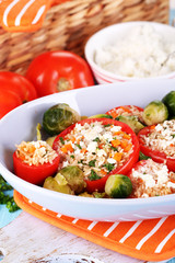 Stuffed tomatoes in bowl on wooden table close-up
