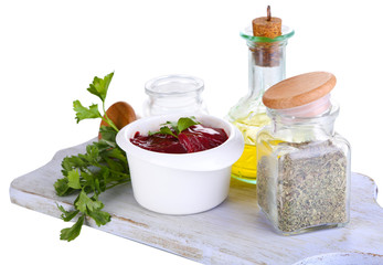 Raw liver in bowl with spices and condiments isolated on white
