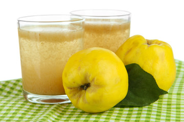 Sweet quince with juice on table on white background