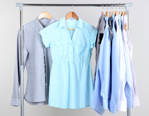 Office clothes on hangers, on gray background