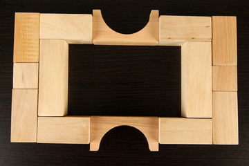 Wooden toy blocks on wooden background