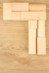 Wooden toy blocks on wooden background