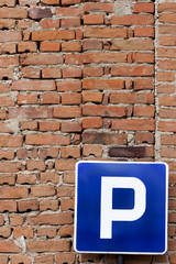 Fototapeta na wymiar Parking Sign Red Bricks