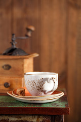 coffee cup with Nostalgic coffee grinder on background