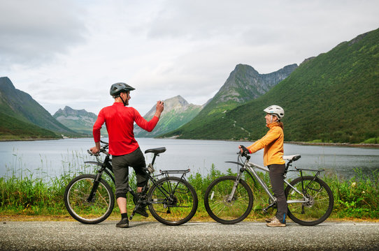 two cyclists relax biking