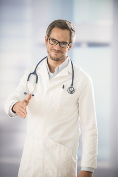 doctor holding out his hand as a sign of hospitality