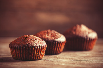 Muffin on wooden table.