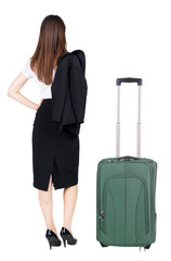 back view of thoughtful business woman traveling with suitcas.