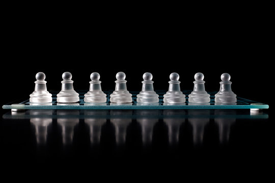 glass chess board with chess pieces