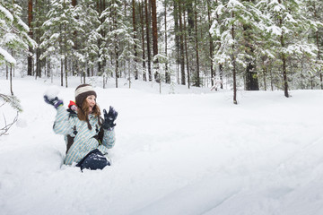 Fototapeta na wymiar Woman throwing snowball outdoors winter