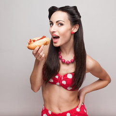 Sexy pinup model eating fast food sandwich