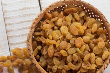 Raisins on wooden background