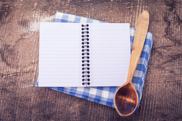 Open empty notebook on wooden background
