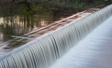 Fototapeta premium motion blurred river weir